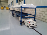 AGV carrying components at factory